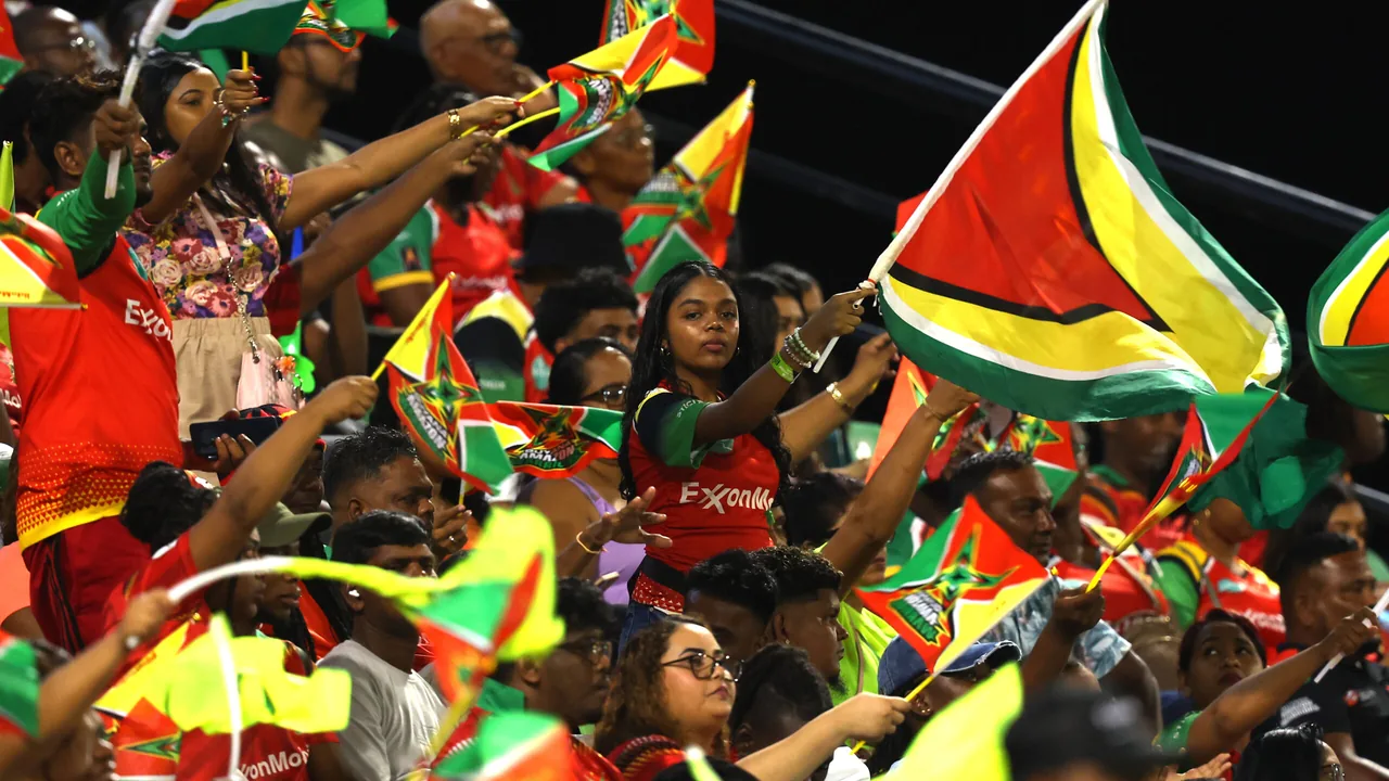 Guyana Amazon Warriors supporters celebrate during a CPL match at Providence Stadium